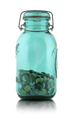 Blue glass jar filled with pennies